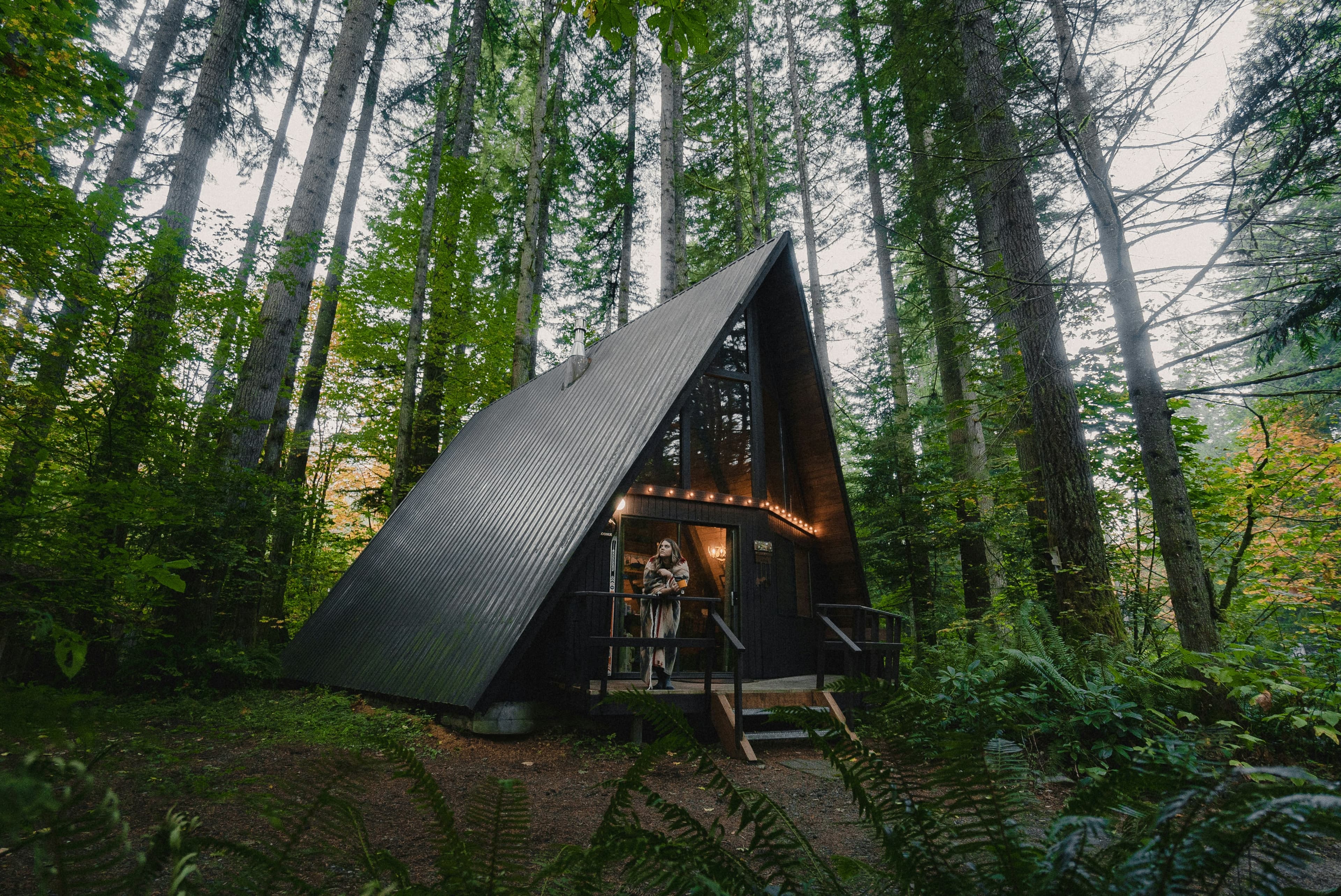 Young lady sitting outside of a luxury cabin